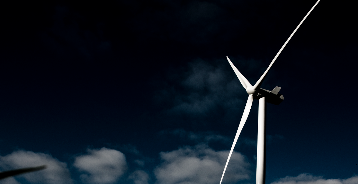A photo showing Vestas 3 megawatt wind turbine with dark and cloudy skies in the background