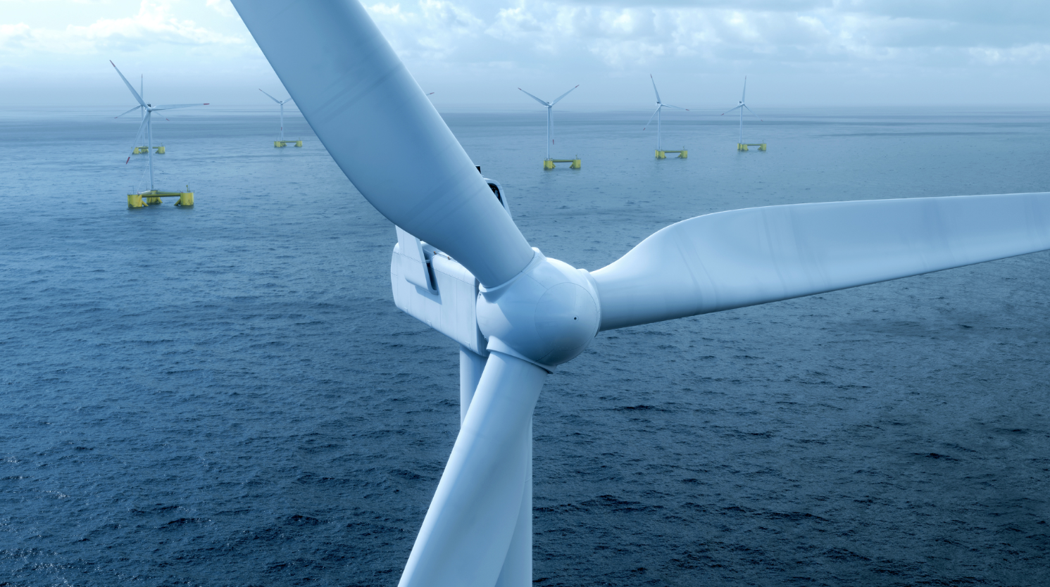 An image of a floating wind farm with one turbine rotor up close