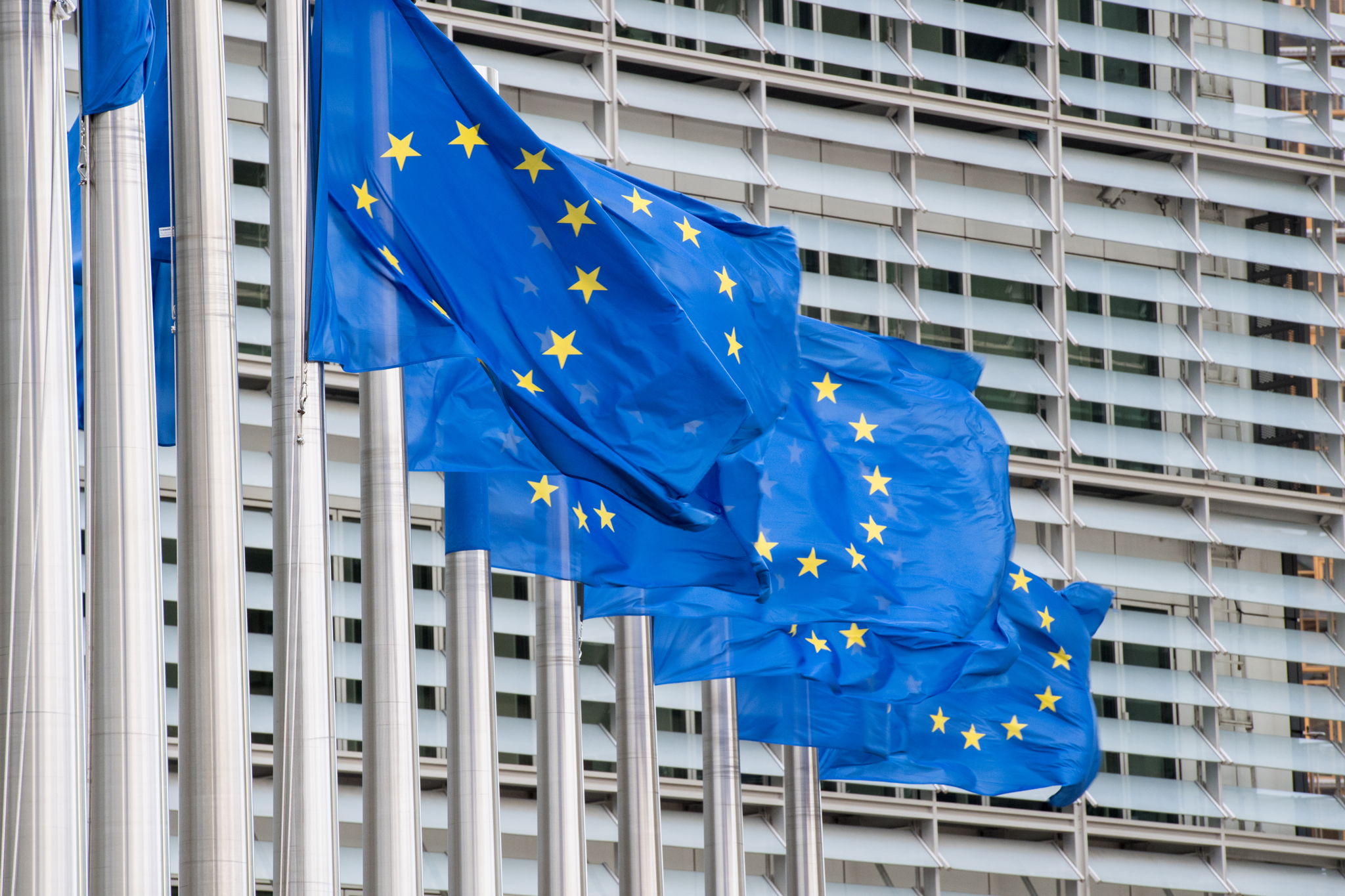 EU flags in front of the European Commission building in Brussels