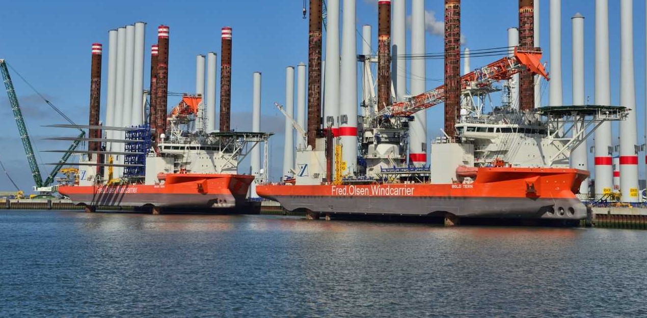 Bold Tern at a port with wind turbine towers on board