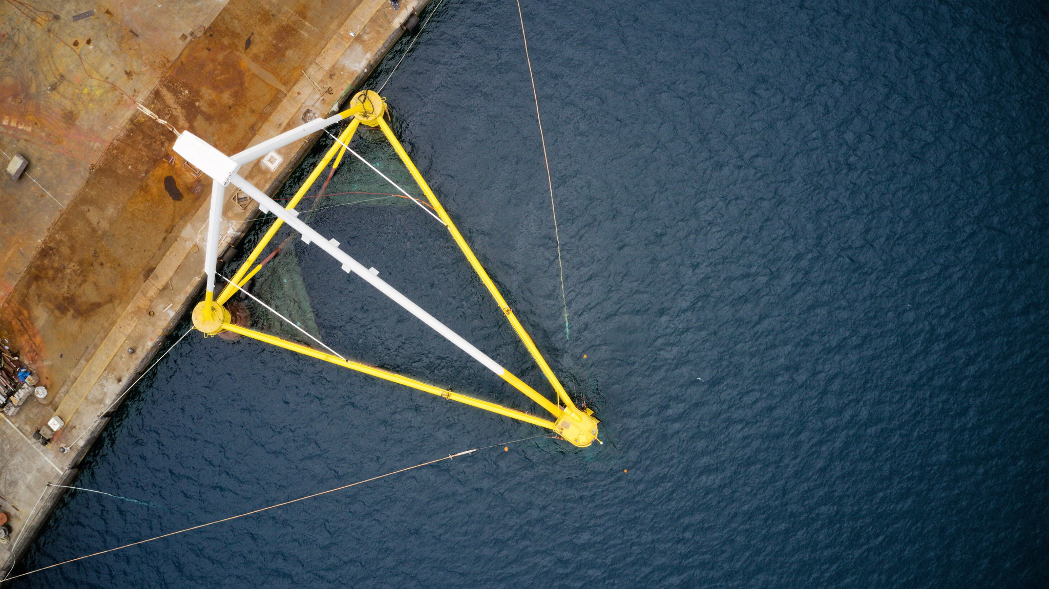 An aerial photo of the PivotBuoy structure with a nacelle installed on top, docked at the Hidramar shipyard