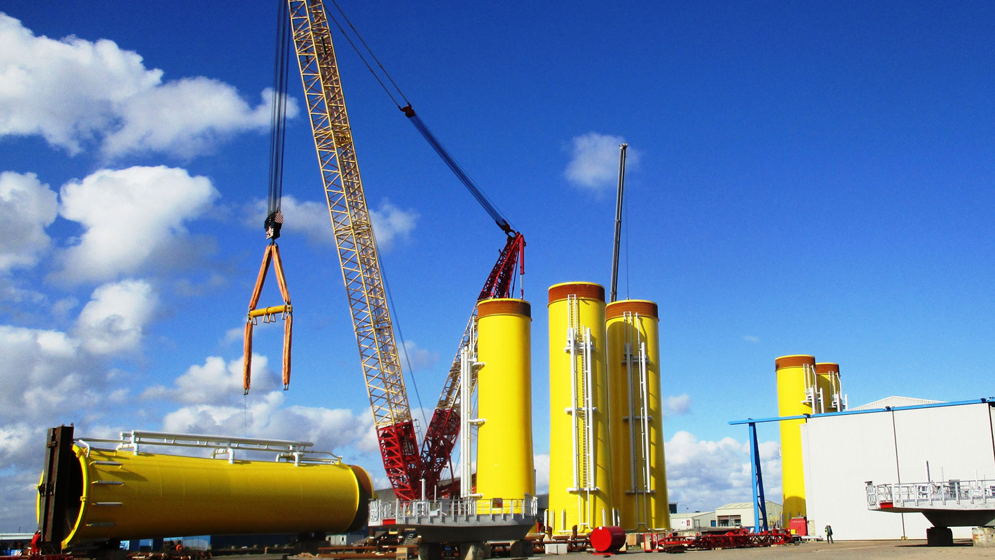 A photo of yellow transition pieces being upended at a yard