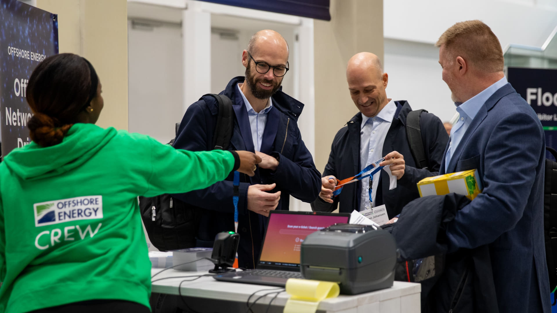 Attendees collecting their badges at the entrance to Offshore Energy Exhibition and Conference 2023