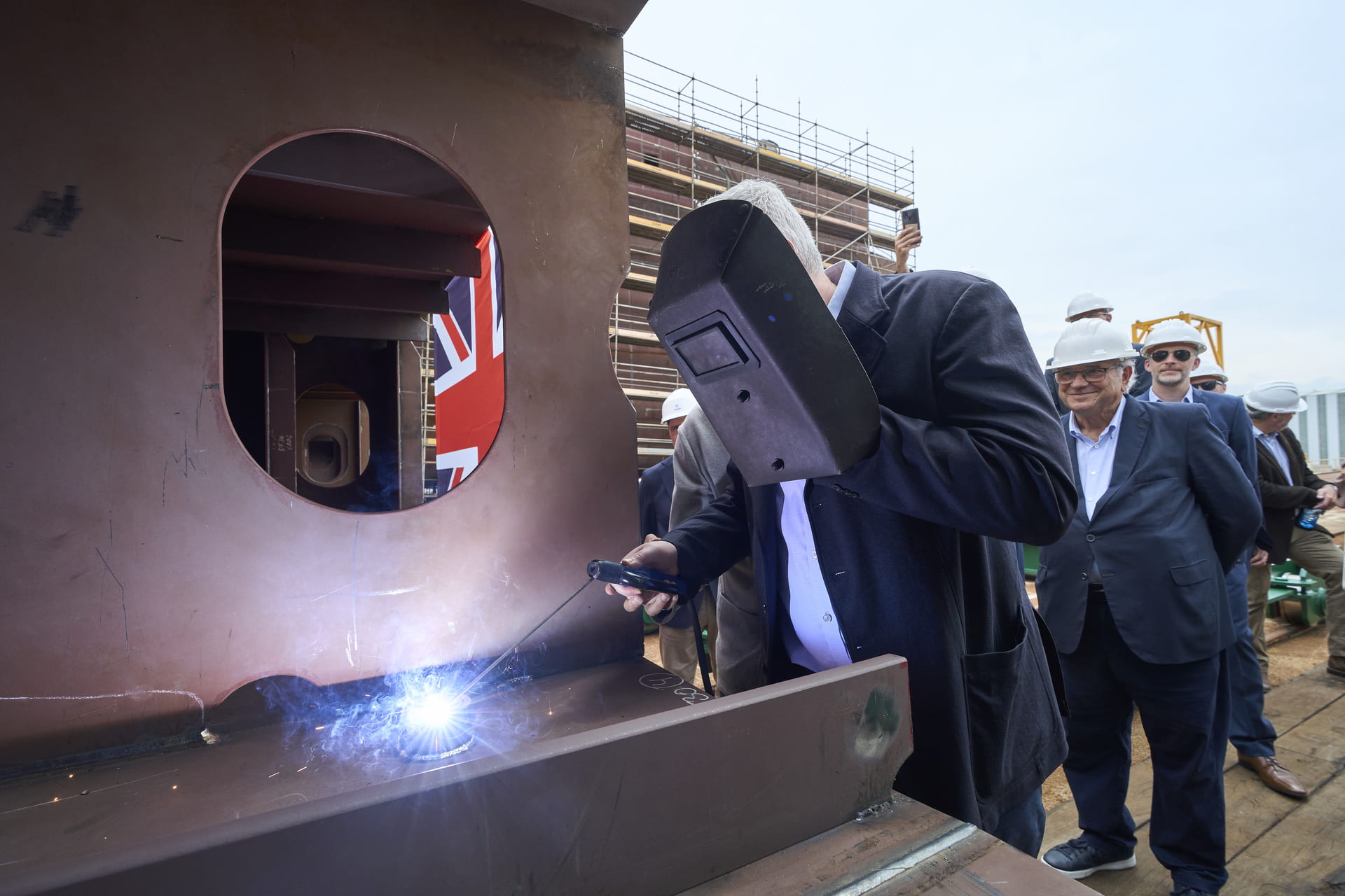 Bibby Line Group CEO Jonathan Lewis welding a coin into keel plates of first eCSOV